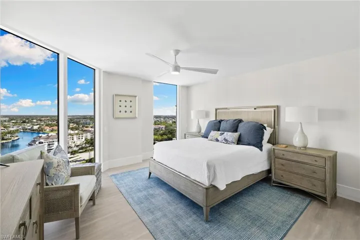 Bedroom featuring floor to ceiling windows, ceiling fan, access to exterior, and light wood finished floors