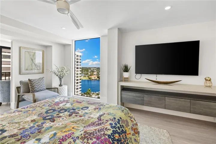 Bedroom featuring light wood-type flooring, ceiling fan, and recessed lighting
