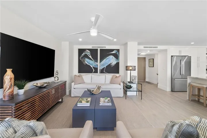Living room with light wood-type flooring, recessed lighting, and ceiling fan