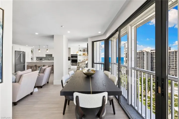 Dining area with recessed lighting, light wood finished floors, and a water view