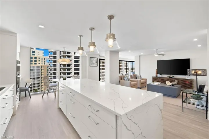 Kitchen with white cabinets, modern cabinets, hanging light fixtures, and recessed lighting
