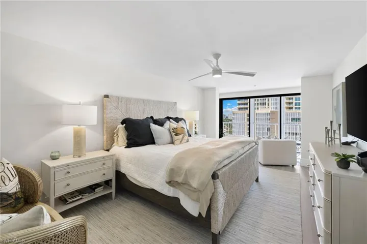 Bedroom featuring a ceiling fan and floor to ceiling windows