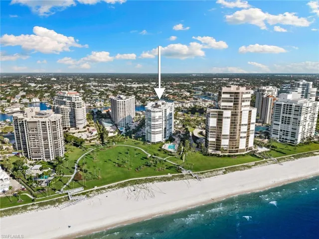 View of urban area featuring waterfront with a beach
