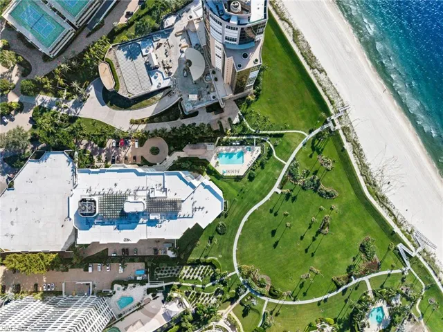 View of property location with a pool area and extended coastline