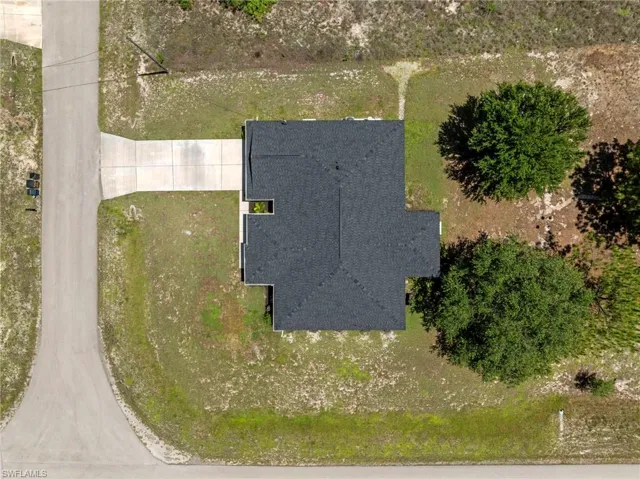 Overhead view of home with mature trees and roof replaced in 2025