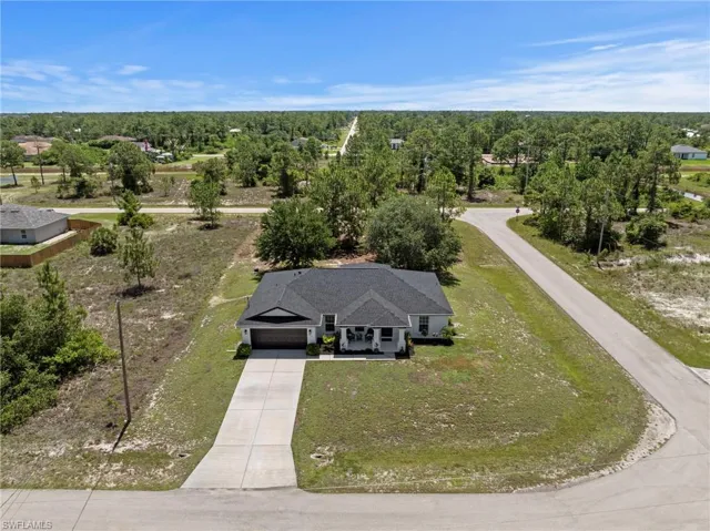 Overhead view of home with mature trees and roof replaced in 2025