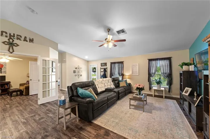 Living room featuring luxury vinyl plank flooring installed in 2021 overlooking den