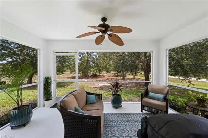 Rear screened lanai with fresh paint and upgraded outdoor fan overlooking a generous yard with over 1/2 acre of space to enjoy!