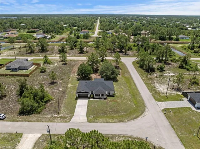 Overhead view of home with mature trees and roof replaced in 2025
