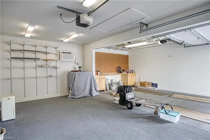 Garage with a garage door opener and an AC wall unit