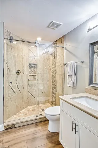 Guest bedroom with a raised ceiling, crown molding,