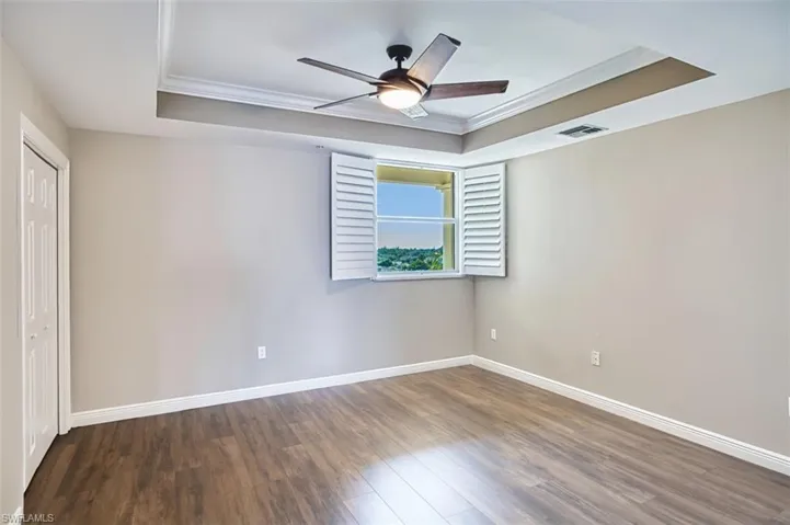 Guest en-suite 2nd primary bedroom with a raised ceiling, crown molding,