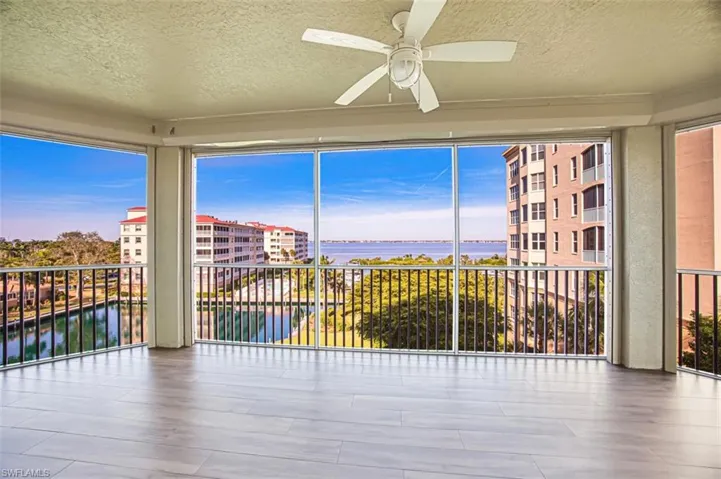 Unfurnished sunroom with a water view and plenty of natural light