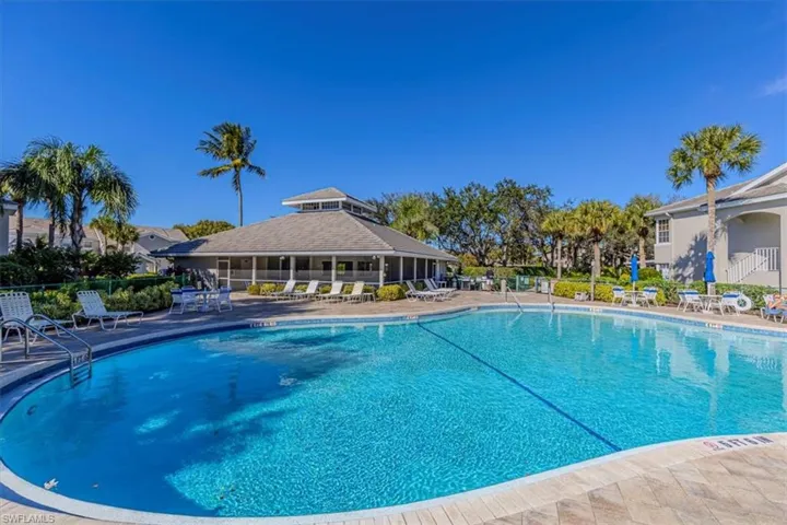 Community pool with a patio