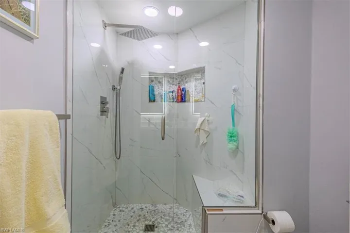 Bathroom with a marble finish shower