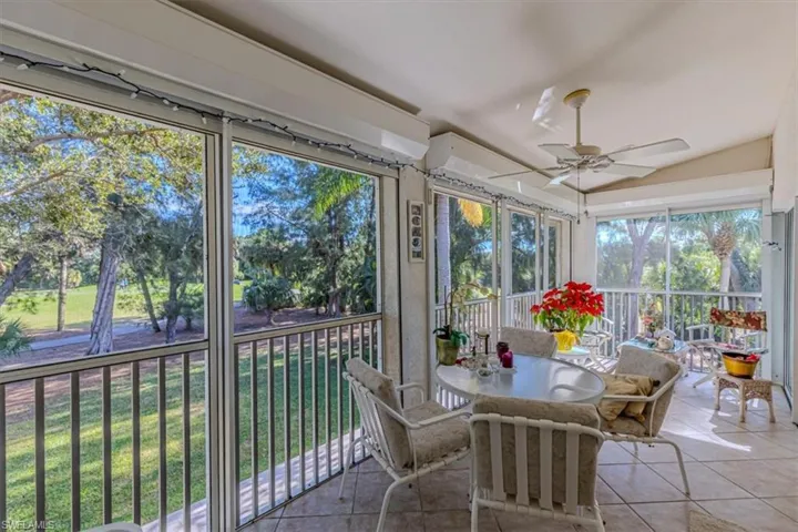 Sunroom / solarium featuring tile patterned floors and lofted ceiling