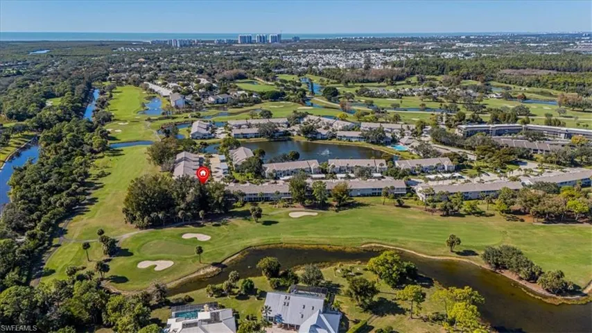Aerial perspective of suburban area featuring a large body of water