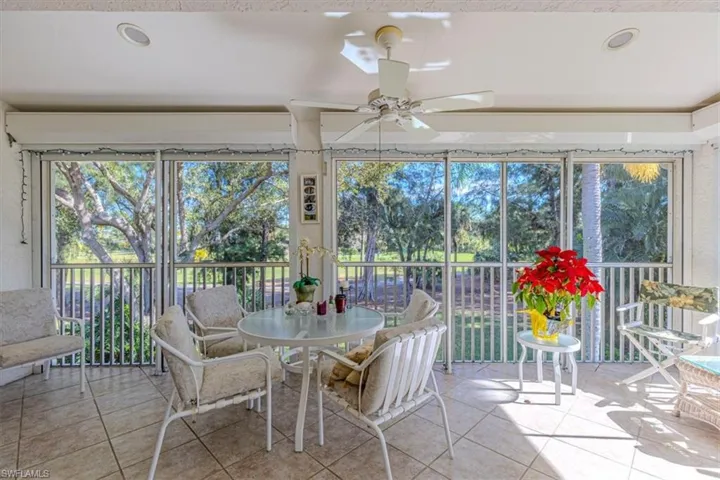 Sunroom with tile patterned floors and recessed lighting