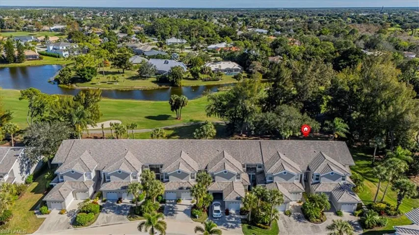 Aerial view of residential area with a golf club and a large body of water