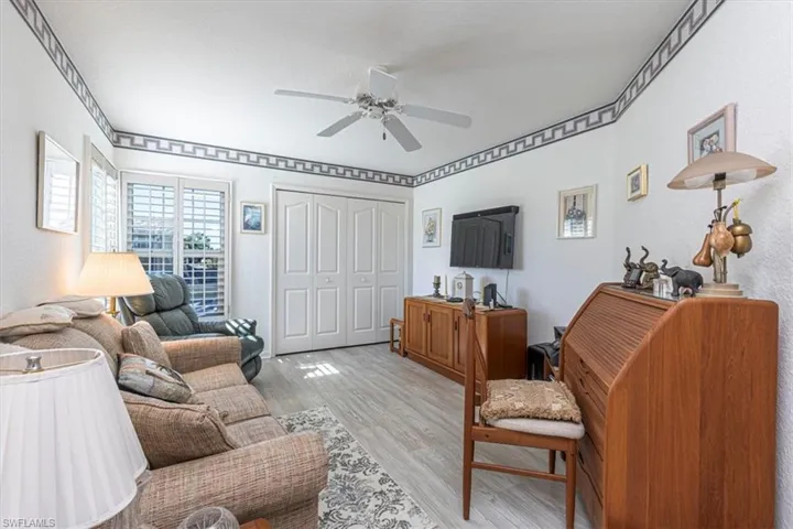 Living area featuring light wood finished floors and ceiling fan