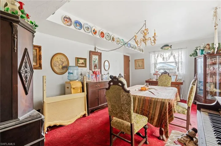 Dining room with a chandelier and carpet flooring