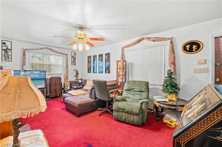 Living room with carpet floors and ceiling fan