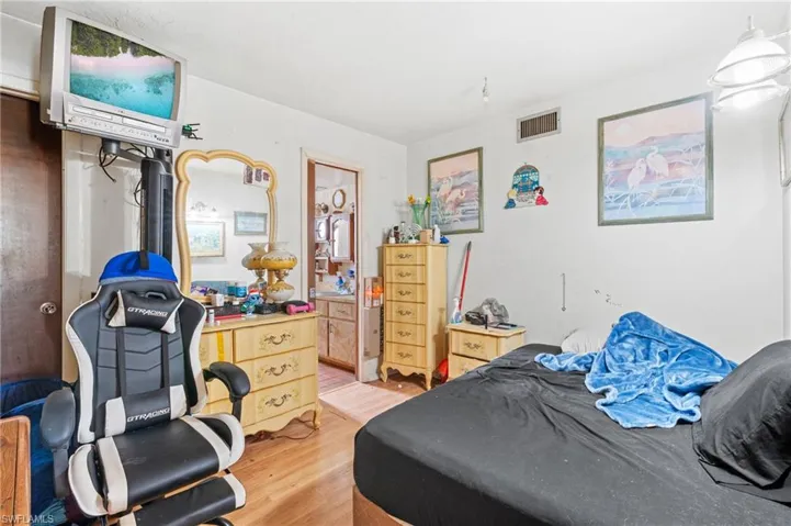 Bedroom with hardwood / wood-style flooring
