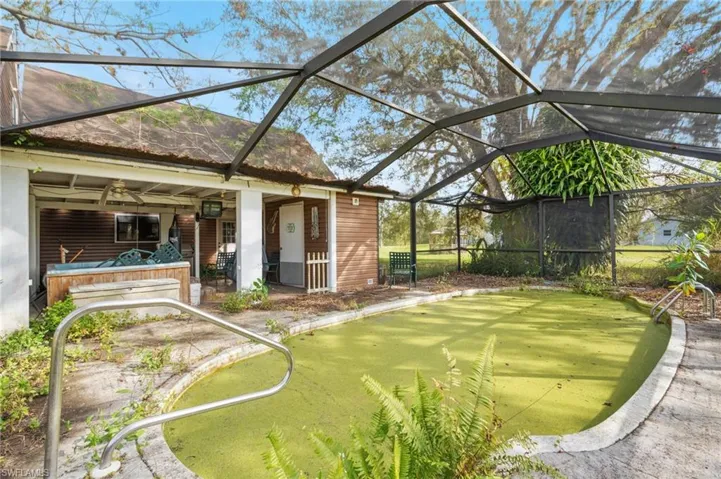 View of yard with ceiling fan and glass enclosure