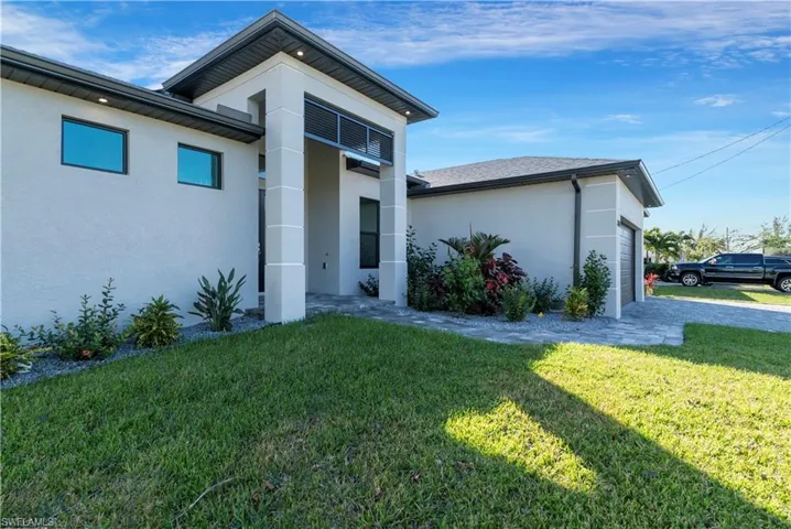 View of home's exterior featuring a yard and a garage