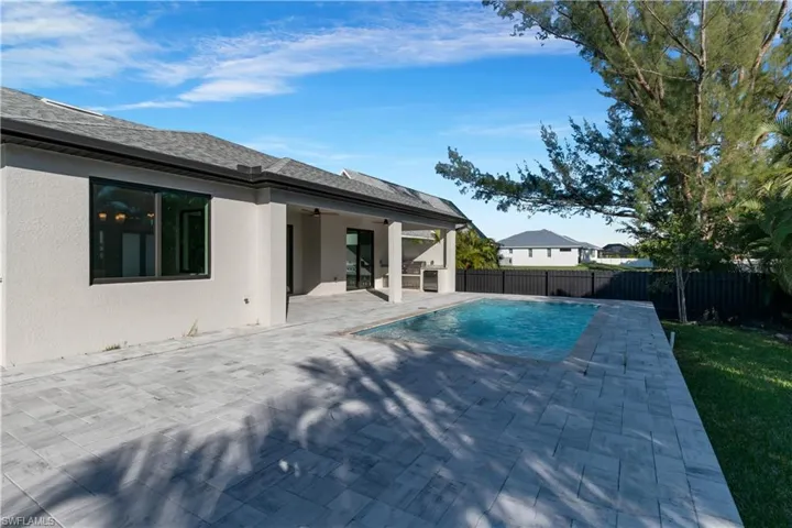 View of swimming pool featuring a patio area and ceiling fan