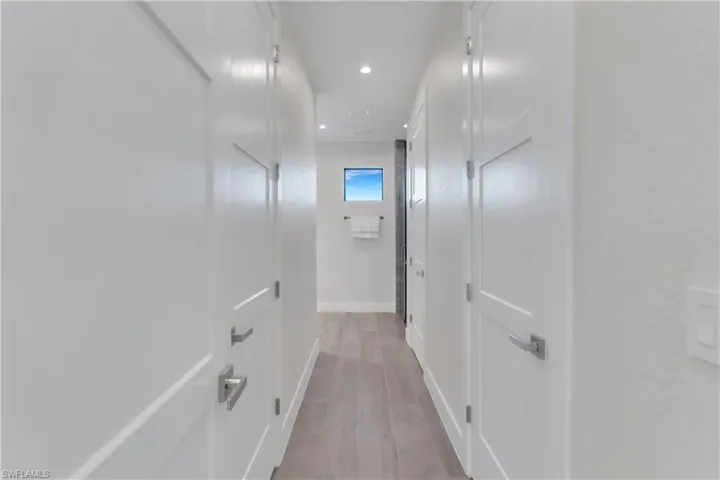 Hallway with light hardwood / wood-style floors