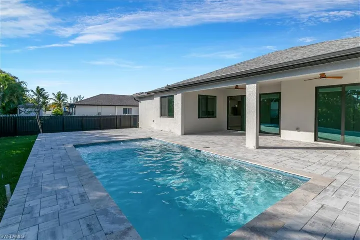 View of pool with ceiling fan and a patio area