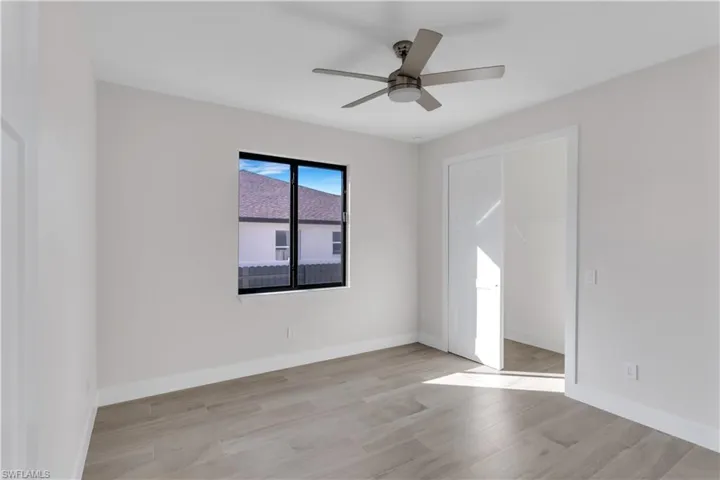 Empty room with light wood-type flooring and ceiling fan