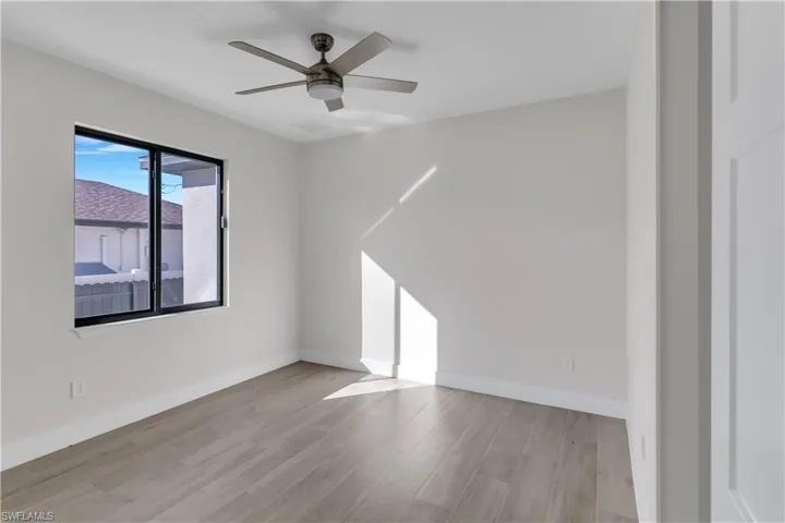 Empty room featuring ceiling fan and light hardwood / wood-style flooring