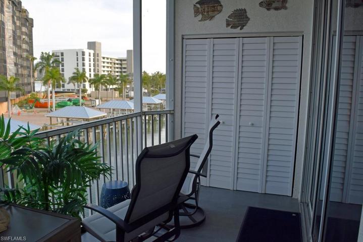 VIEW FROM OWNER'S SUITE AREA OF LANAI.  WASHER AND DRYER BEHIND LOUVERED DOORS.  LANAI SCREENS REPLACED IN 2017.  PLANK TILE FLOORING.