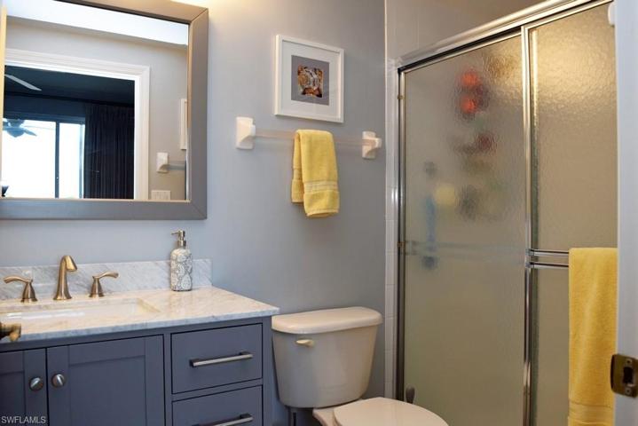 OWNER'S SUITE BATH.  UPDATED VANITY, MIRROR AND LIGHTING.