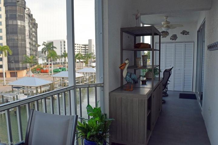 SPACIOUS TILED AND SCREENED LANAI WITH BAY AND CANAL VIEWS.  ENTRANCE TO OWNER'S SUITE IS SHOWN AT RIGHT REAR.  WASHER AND DRYER ARE BEHIND LOUVERED DOORS.