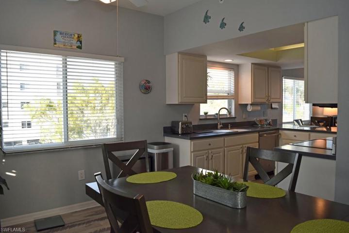 VIEW FROM DINING AREA INTO KITCHEN.  BLINDS ON ALL WINDOWS.