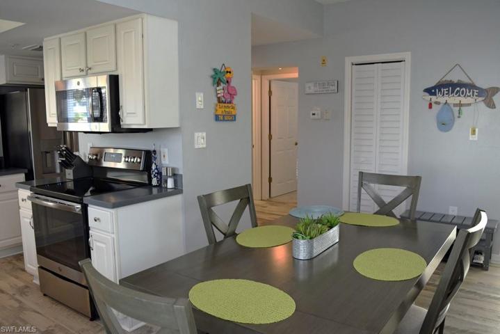 VIEW FROM DINING AREA TOWARDS KITCHEN.  GUEST BATH AND GUEST BEDROOM ENTRANCE SHOWN AT MIDDLE REAR.  ENTRY TO UNIT IS TO RIGHT.