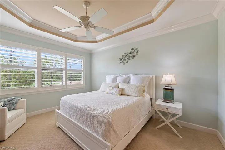 Stunning with big windows outfitted with Plantation Shutters, tray and custom painted ceilings and cool colors.