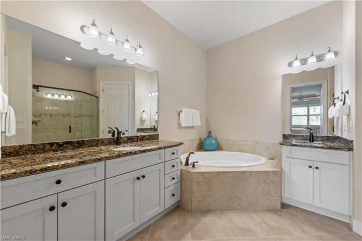 Double vanities, bathtub, and walk-in modern shower.