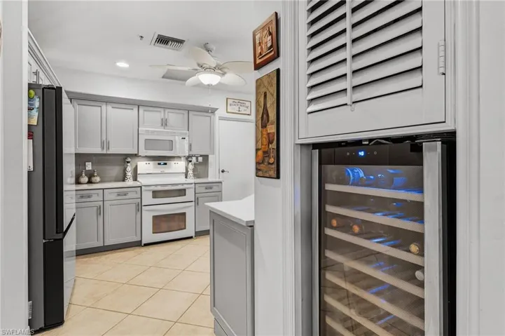 A wine cooler is seamlessly integrated into the space, offering both convenient functionality and efficient storage.