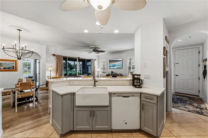 Enjoy views of the golf course while the chef prepares an exceptional meal in a beautifully appointed kitchen featuring a farmhouse sink.