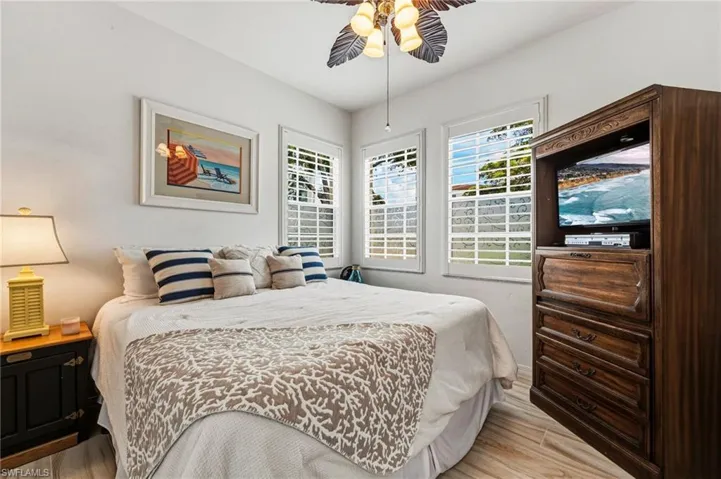 The second bedroom is filled with abundant natural light and enhanced by elegant plantation shutters.