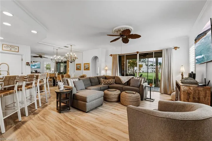 The fully furnished turnkey condo features an open and spacious living area, showcasing stunning views of the golf course and lake.
