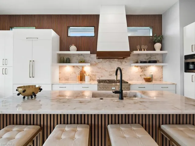 Waterfall island, integrated Miele coffee system, and custom cabinetry
