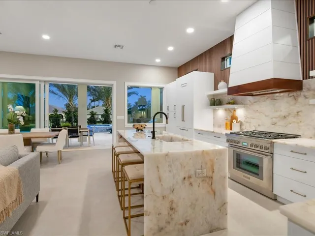 Designer kitchen with Thermador gas range and oversized paneled refrigeration