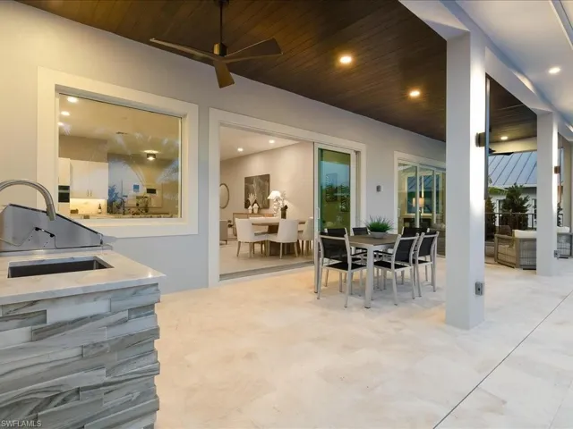 Covered outdoor entertaining space adjacent to pool and spa