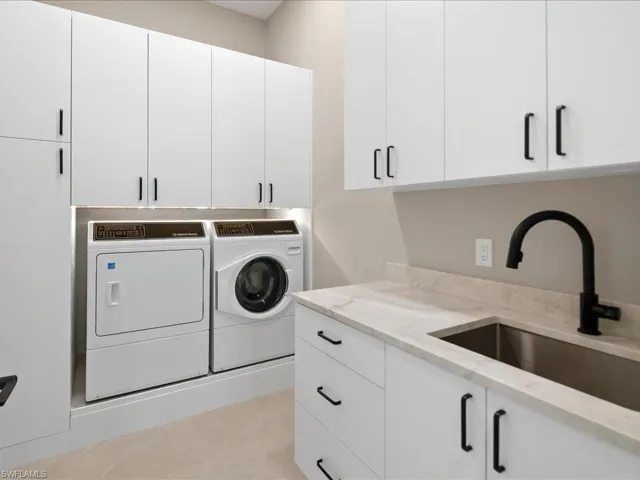 Well-appointed laundry room with additional storage and utility sink