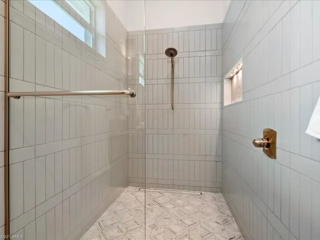 Spacious walk-in shower with statement tilework